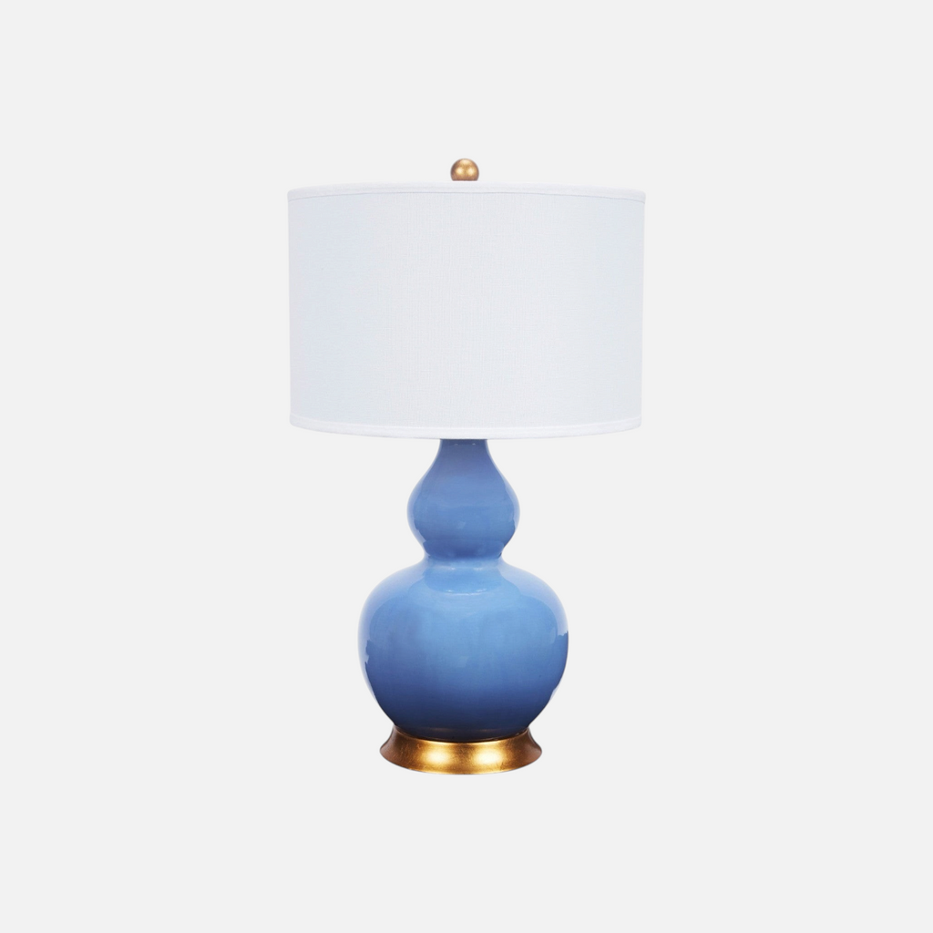 Citrine Home Parisian Blue ceramic table lamp with a white linen shade and gold base accents.