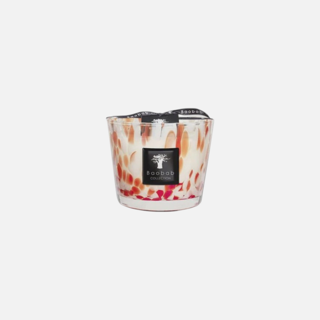 Citrine Home Pearls Coral scented candle in hand-blown glass with coral-colored accents and a black logo label.