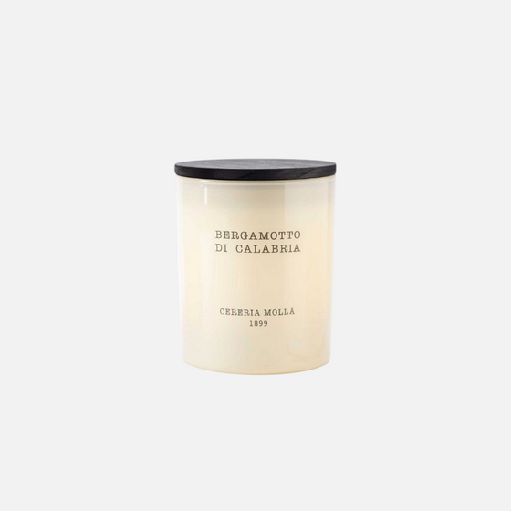 Citrine Home Bergamotto di Calabria 8 oz scented candle in a cream glass jar with a black wooden lid.
