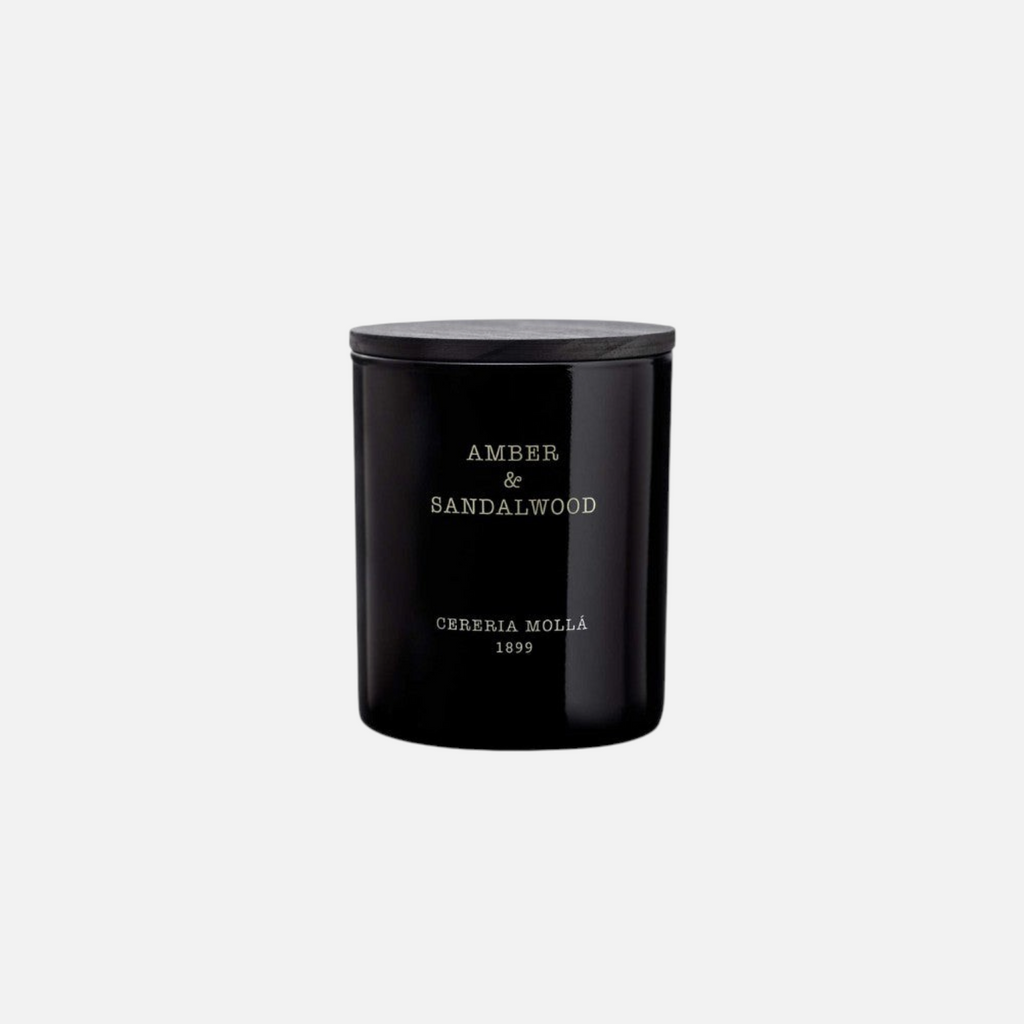 Citrine Home Amber & Sandalwood 8 oz scented candle in a sleek black glass jar with a dark wooden lid.