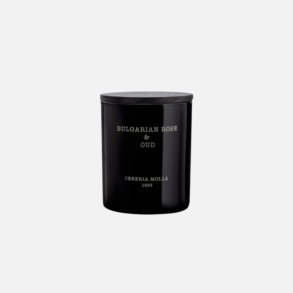 Citrine Home 8 oz Bulgarian Rose & Oud scented candle in a sleek black glass jar with a matching wooden lid.