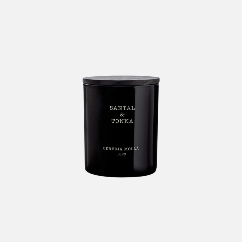 Citrine Home Santal & Tonka 8 oz scented candle in a sleek black glass jar with a dark wooden lid.