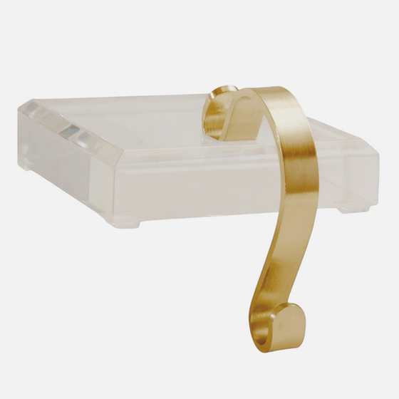 Citrine Home acrylic stocking holder featuring a clear square base and a brushed gold metal hook for holiday decor