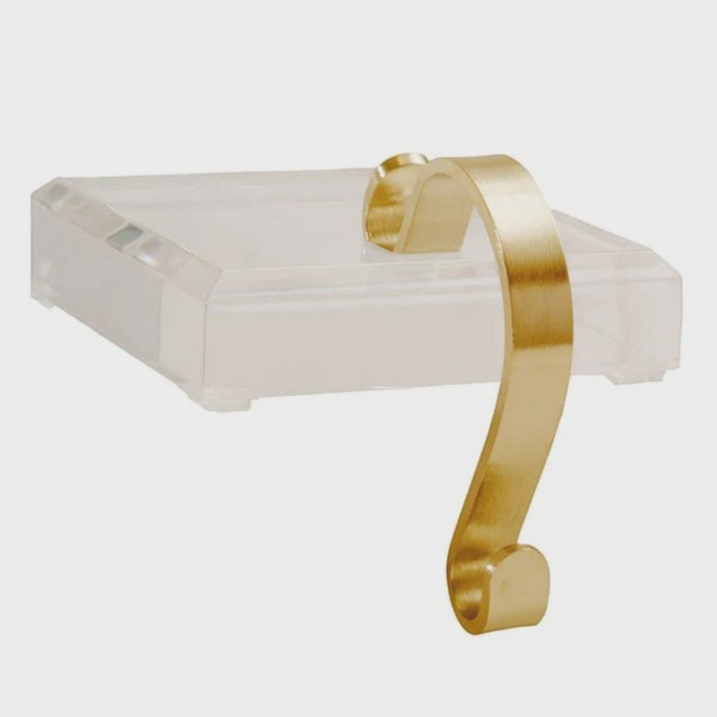 Citrine Home acrylic stocking holder with a brushed gold metal hook for modern holiday mantel decor.