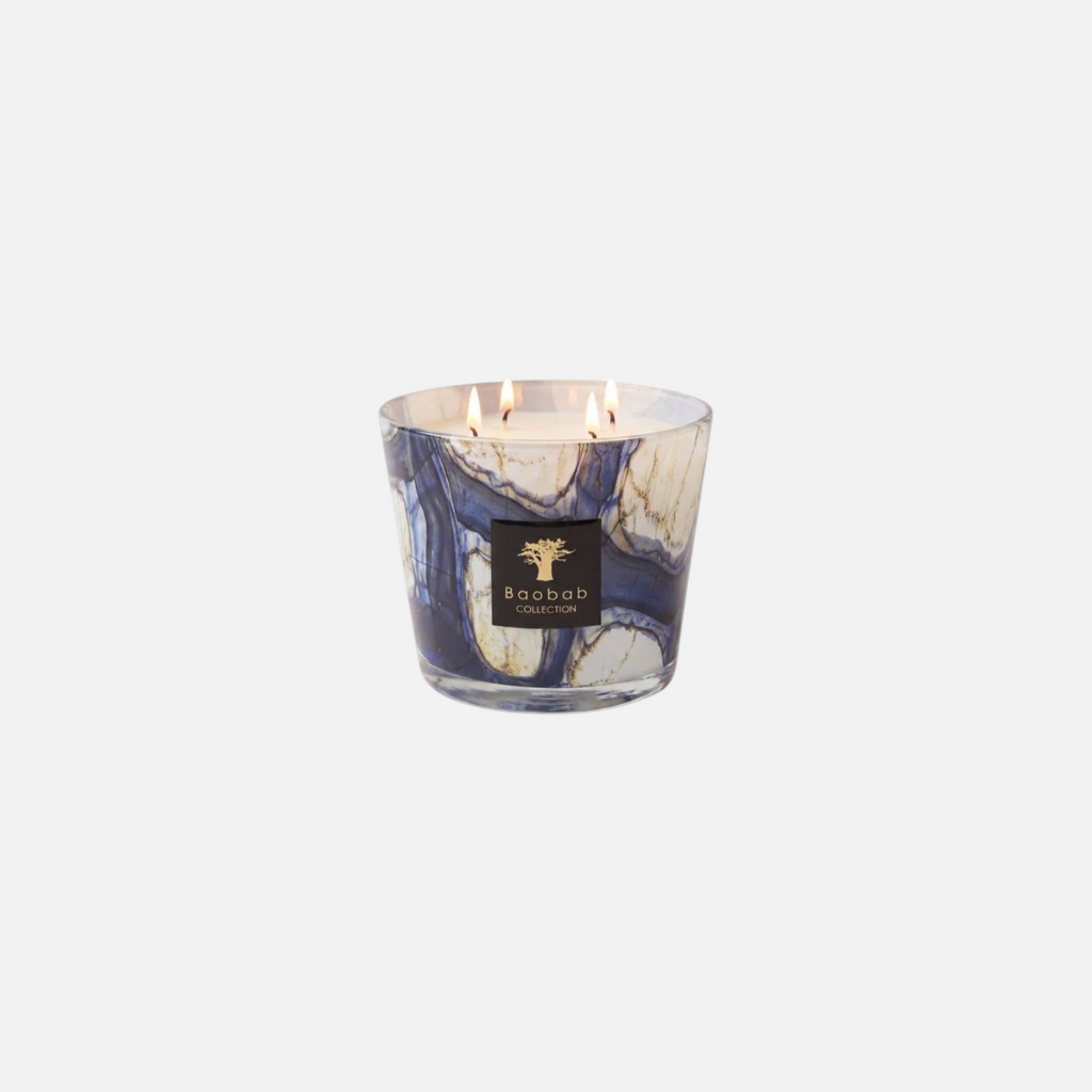 Citrine Home Stones Lazuli scented candle in a blue and white marbled glass vessel with three lit wicks