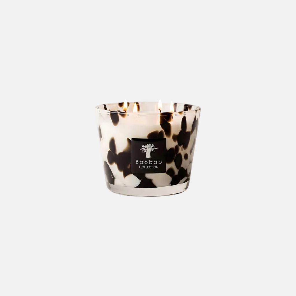 Citrine Home Black Pearls scented candle in a transparent hand-blown glass vessel with black decorative spots.