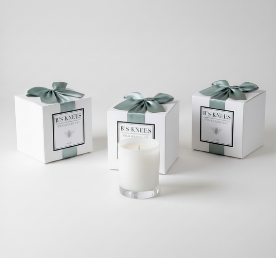 Citrine Home Aleja scented candle in a glass jar with three gift-boxed candles featuring sage green ribbon bows.
