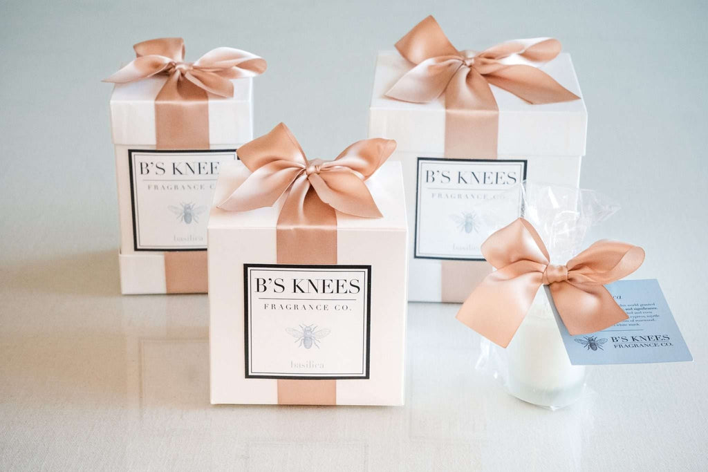 Citrine Home Basilica fragrance gift set in white boxes with rose gold satin ribbons and elegant branding.