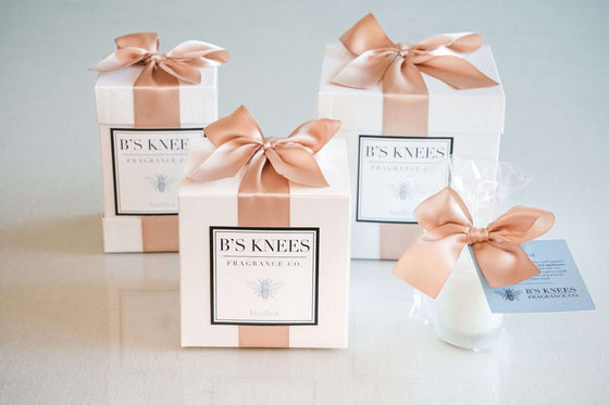 Citrine Home Basilica fragrance gift set in white boxes with rose gold satin ribbons and elegant branding.