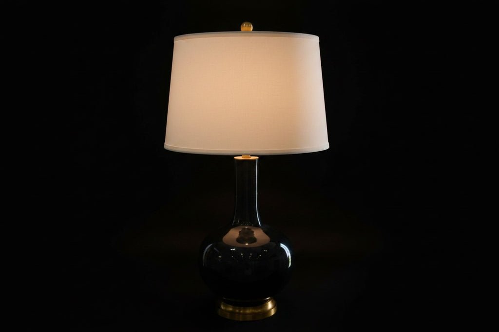 Citrine Home vintage black crackle glaze porcelain bottle lamp with a gold gilt base and white drum shade.