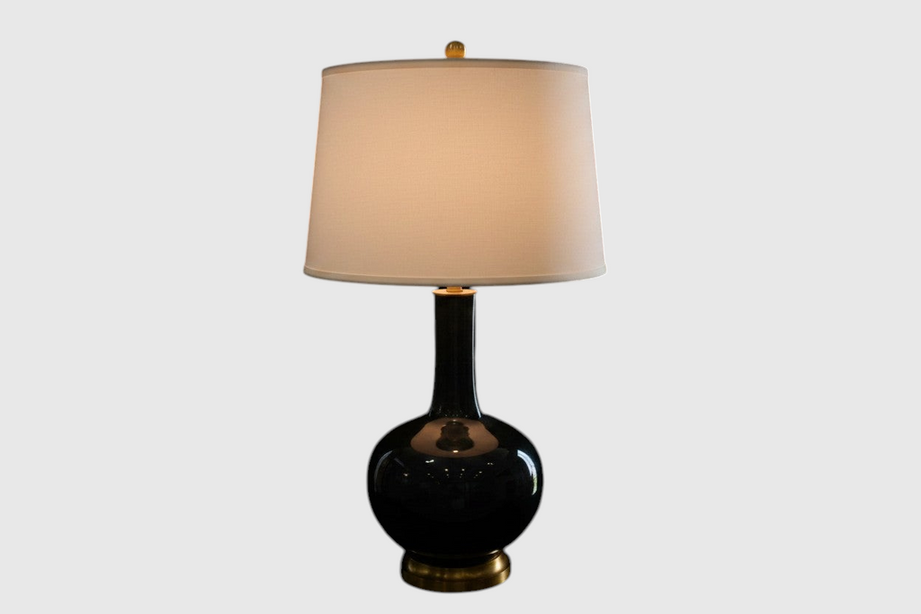 Citrine Home vintage black crackle glaze porcelain bottle lamp with a gilt base and a neutral drum shade.