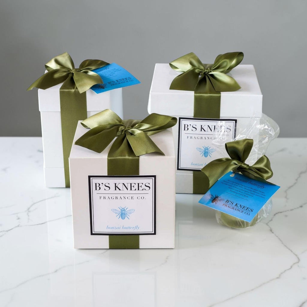 Citrine Home Bonzai Butterfly 2-wick candle gift sets in white boxes with green satin ribbons on a marble surface