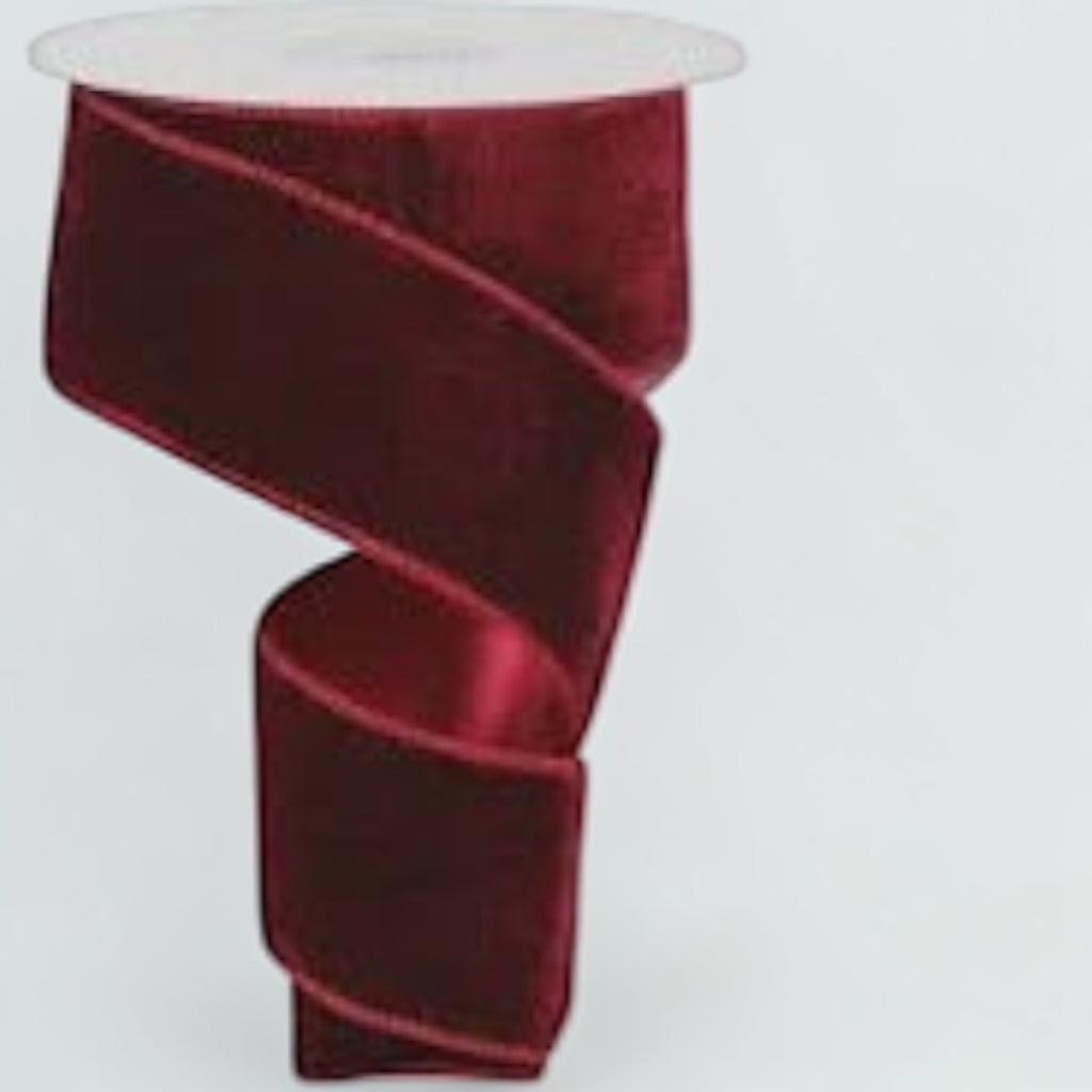 Citrine Home burgundy velvet holiday ribbon on a spool, 2.5 inches wide, perfect for festive gift wrapping.