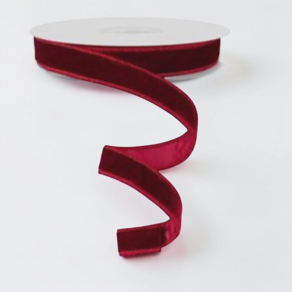 Citrine Home burgundy velvet holiday ribbon on a spool, 1.5 inches wide, perfect for festive gift wrapping.