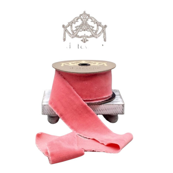 Citrine Home coral velvet ribbon on a spool, 2.5 inches wide, featuring a soft texture and frayed edges.