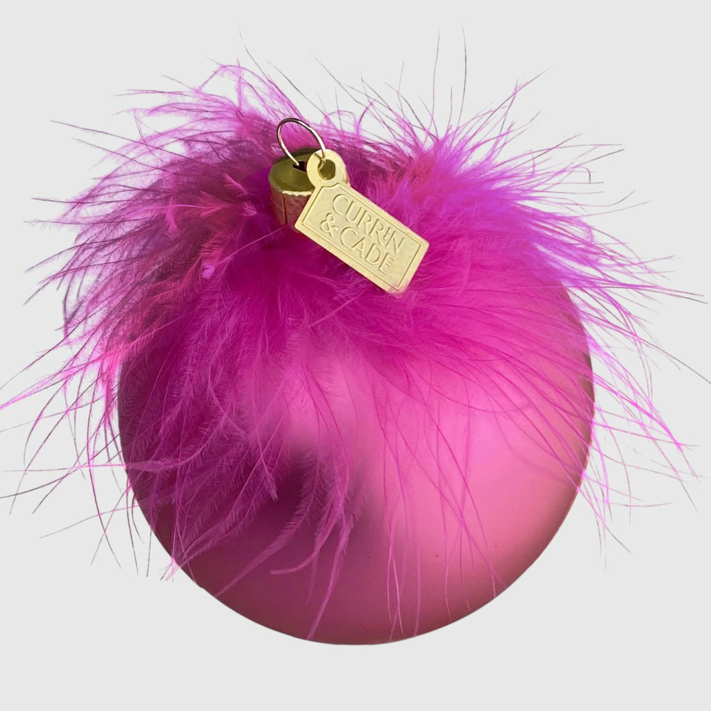Citrine Home fuchsia glass Christmas ornament with soft pink feathers and a gold branded tag