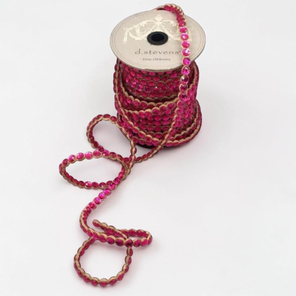 Citrine Home Fuchsia Crown Jewel ribbon on a spool, featuring sparkling pink rhinestones on a gold trim