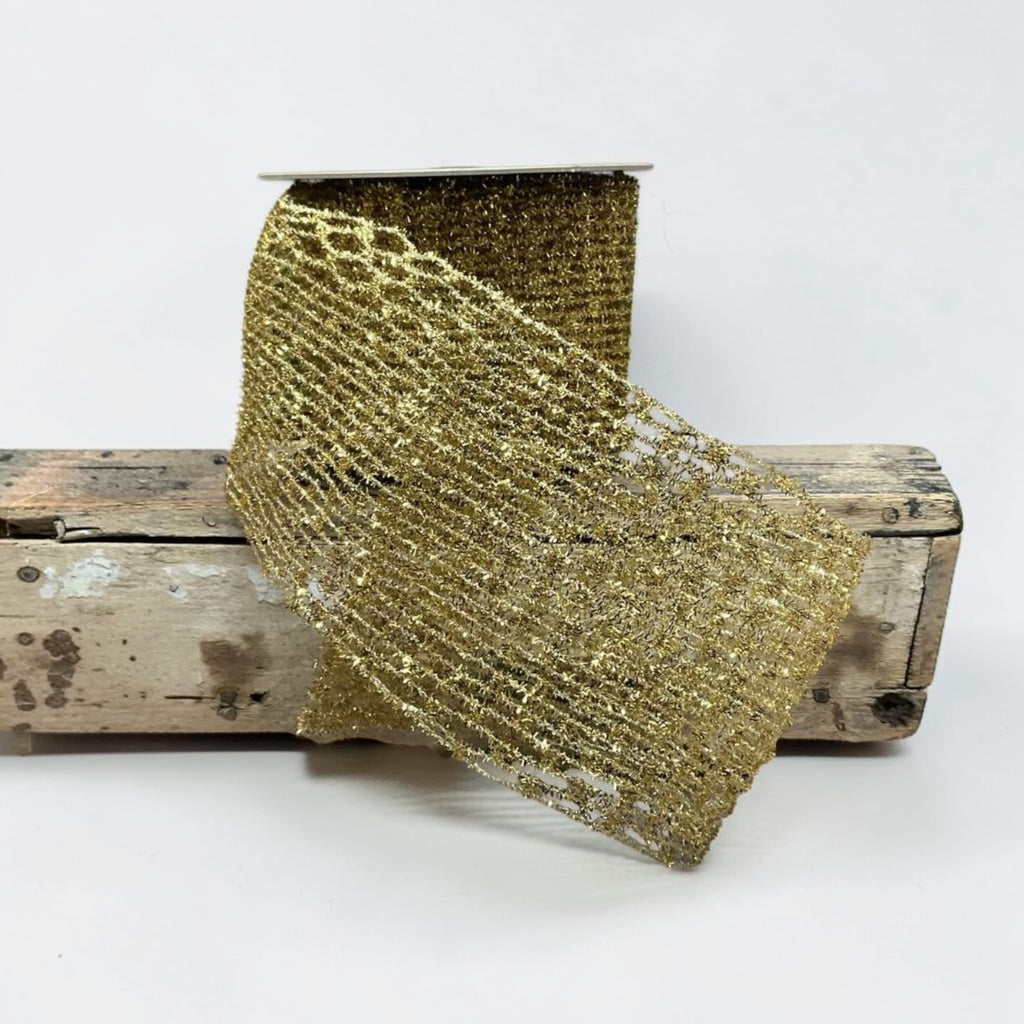 Citrine Home 4-inch wide gold tinsel stretch ribbon with a shimmering open-weave mesh texture on a wooden spool.