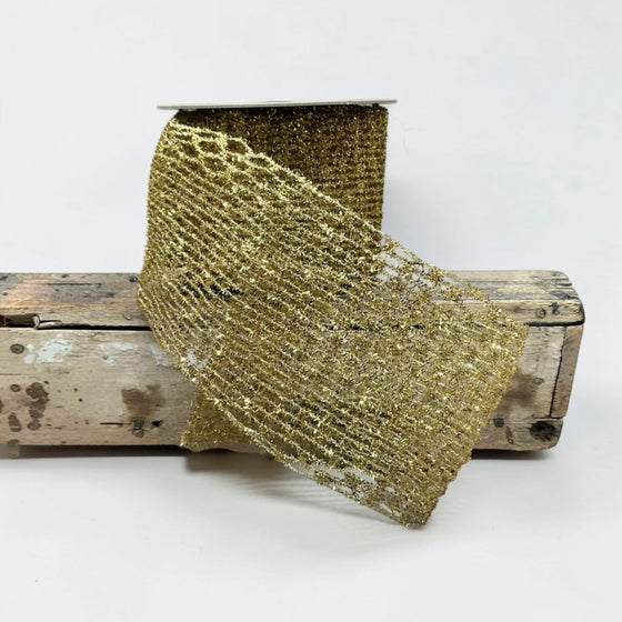 Citrine Home 4-inch wide gold tinsel stretch ribbon with a shimmering open-weave mesh texture on a wooden spool.