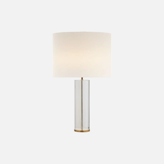 Citrine Home Lineham crystal table lamp with a cylindrical clear glass base and a large white fabric drum shade.