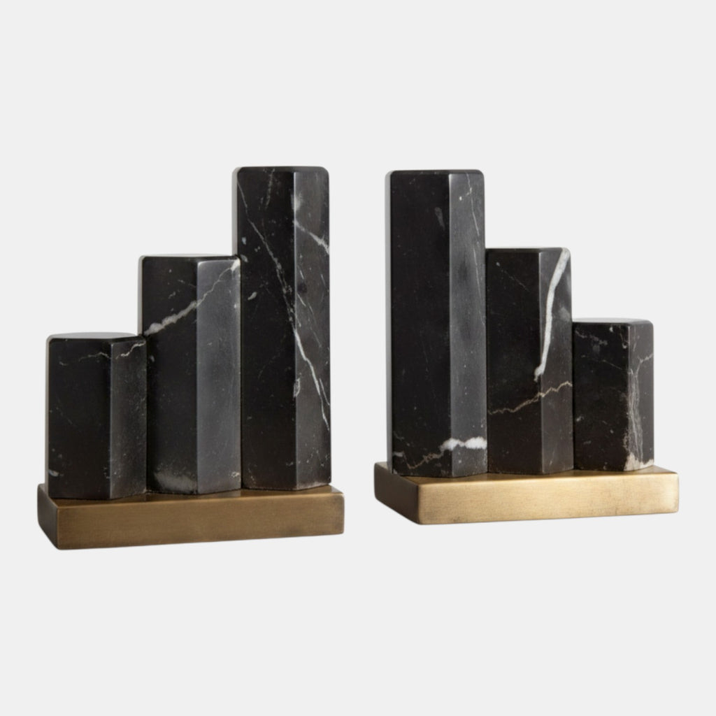 Citrine Home Nate bookends featuring staggered hexagonal black marble pillars on an antique brass base.