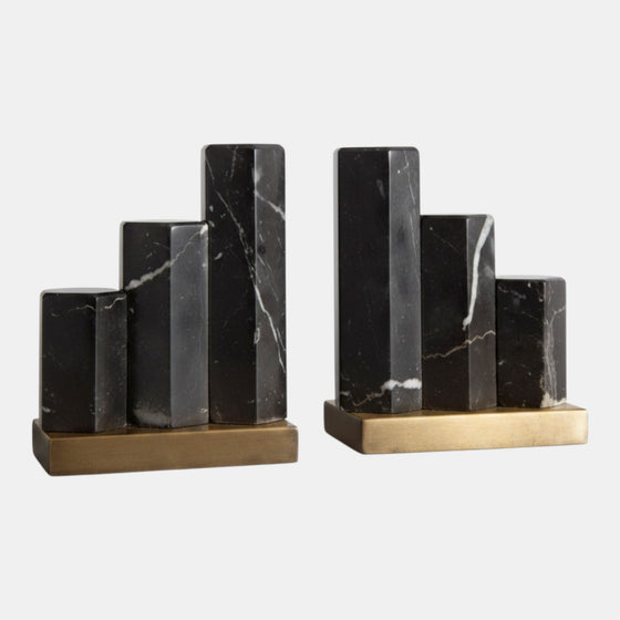 Citrine Home Nate bookends featuring staggered hexagonal black marble pillars on an antique brass base.