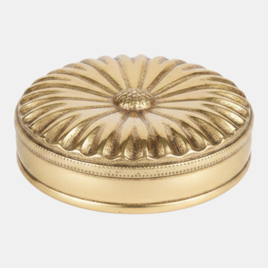 Citrine Home Pulsante brass box featuring a round shape with a decorative sunburst lid and beaded edge detail.