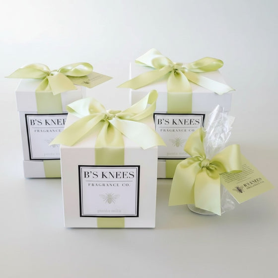 Citrine Home Punta Mita fragrance gift boxes with white packaging and light green satin ribbons