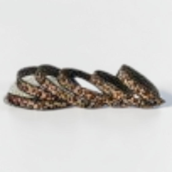 Citrine Home 1-inch wide faux leather ribbon featuring a cream and brown safari animal print pattern.