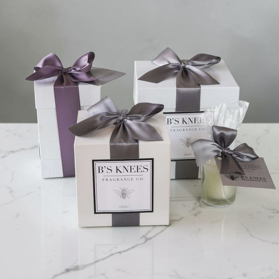 Citrine Home Slate 2-wick candle gift set in white boxes with grey satin ribbons on a marble surface