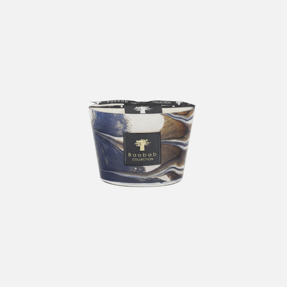 Citrine Home Delta Nil hand-blown glass candle with blue and gold marbled design and papyrus blossom fragrance